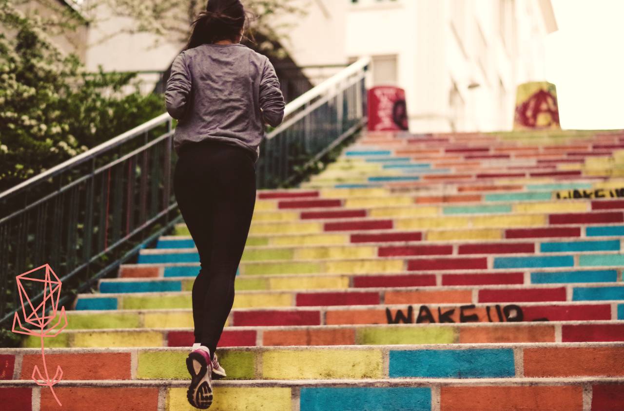 Woman running up brightly coloured steps outdoors